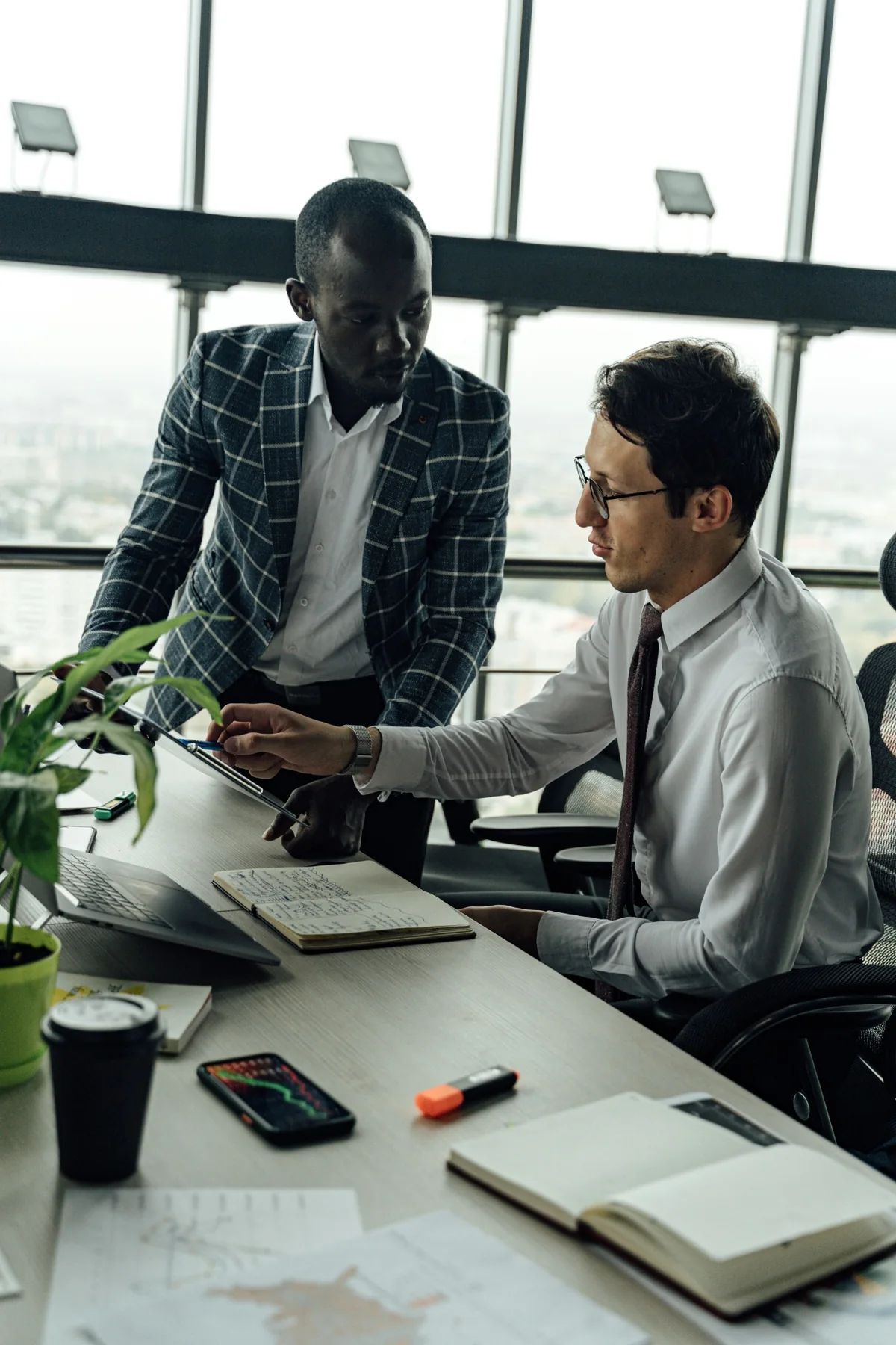 Two professionals reviewing documents and analysis together